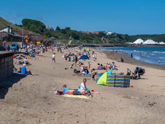 Beach-goers enjoy Scarborough's North Bay in June 2020.
