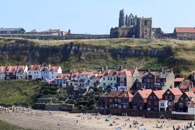 Visitors enjoy the sun and beach in Whitby.