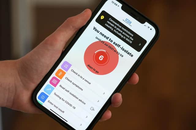The NHS Covid-19 app. Photo illustration by Christopher Furlong/Getty Images
