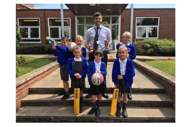 Mark Vasey, centre, receives his award with some of his pupils. (Cayton School)