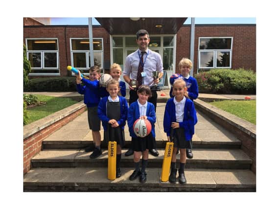 Mark Vasey, centre, receives his award with some of his pupils. (Cayton School)