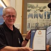 WO Rob Hill presents the long-service award to Garry Owen.