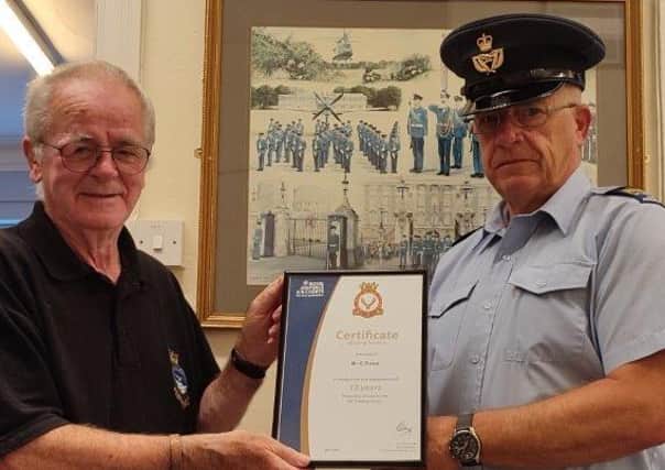 WO Rob Hill presents the long-service award to Garry Owen.