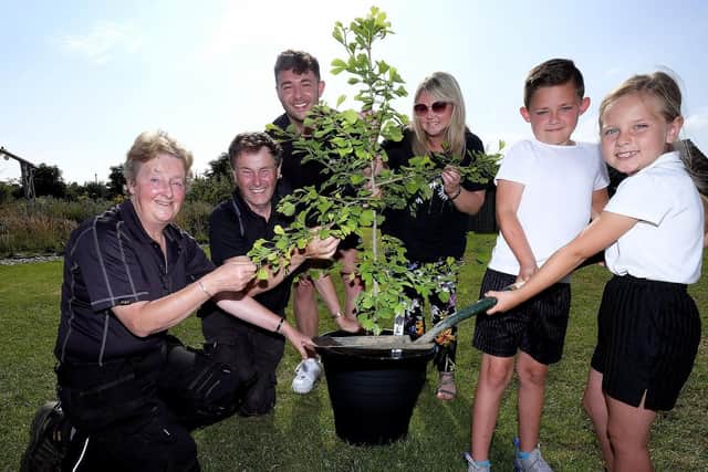 Filey Infant School children ready to plant trees as part of a global initiative .Sheila Johnson and Roger Burnett from Scarborough Borough Council..Teacher Adam Jackson, Head Teacher Angela Clark, with pupils Alfie and Betsy. Pic: Richard Ponter