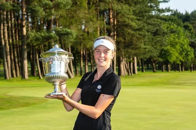 Patience Rhodes holds aloft the silverware at Malton & Norton GC

Photo -Leaderboard Photography)