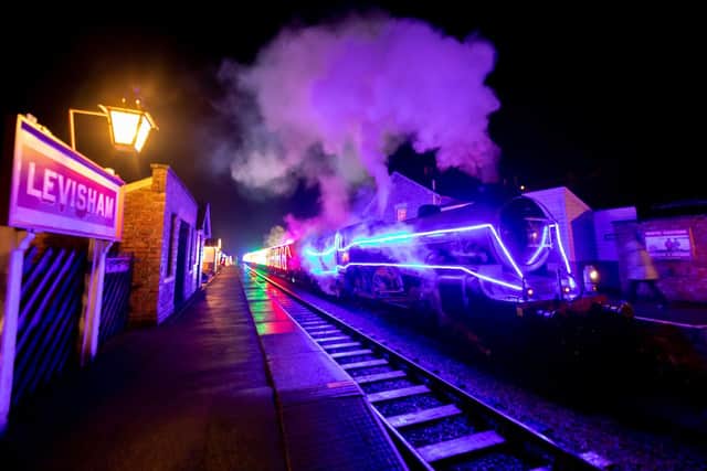 A lit up train at Levisham station on the North Yorkshire Moors Railway.