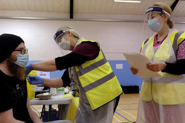 Volunteers administer a coronavirus vaccine at Scarborough Rugby Club.