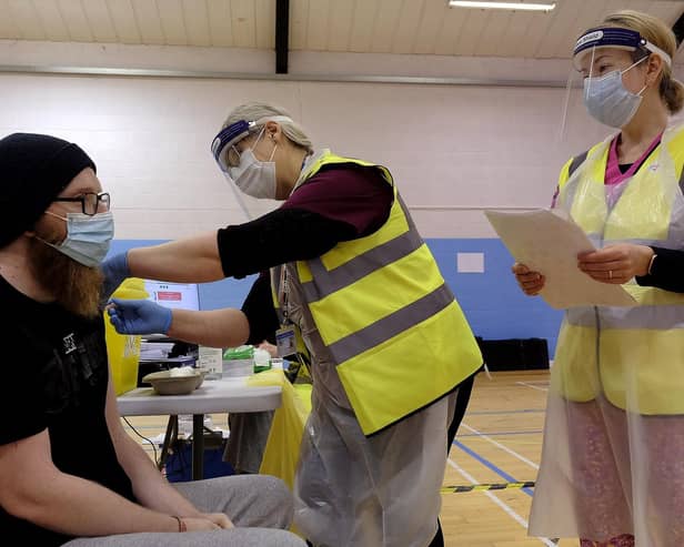 Volunteers administer a coronavirus vaccine at Scarborough Rugby Club.