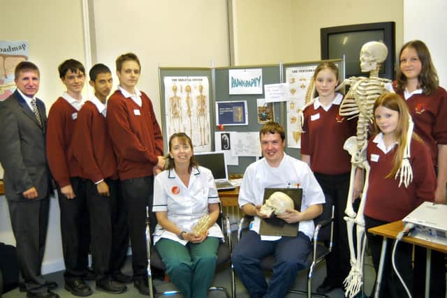 Radiographers Lynn Sunley and Paul Hutchinson are pictured with Bridlington School Sports College teacher Andy Levitt and pupils in 2005. (052659b Aim Higher)