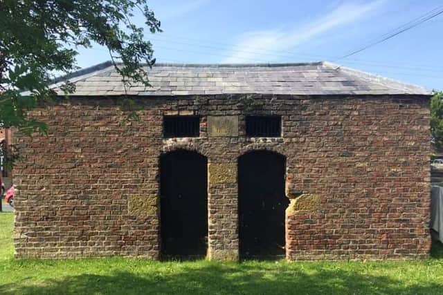 The tiny red-brick lock-up nicknamed the black hole
