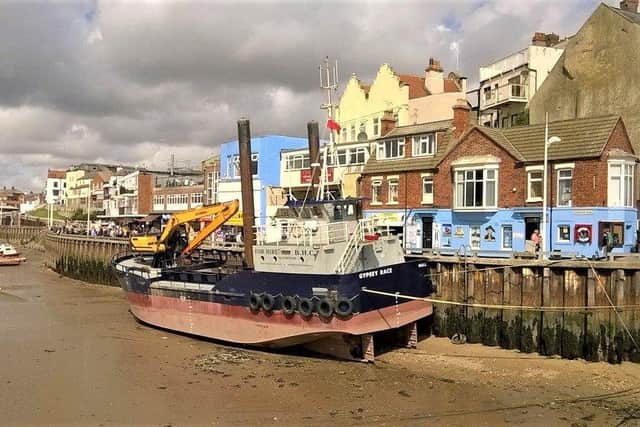 Alan Flynn frames the Gypsey Race dredger at low tide in Bridlington’s harbour.