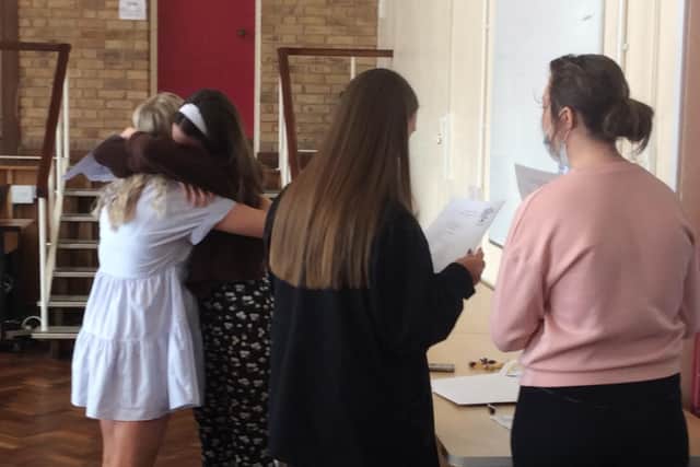 Congratulatory hugs for GCSE students.