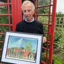 Watercolour artist Andrew Storrie with the Bridlington Town inspired print.