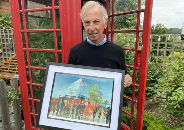 Watercolour artist Andrew Storrie with the Bridlington Town inspired print.