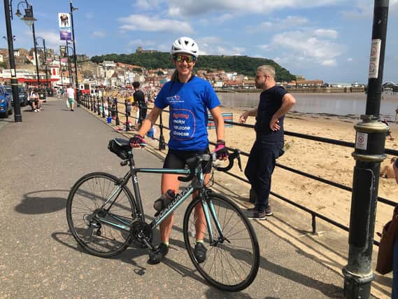 Cathy Wood on her 1,000-mile bike ride fundraiser on Foreshore Road in Scarborough. (Photo: KD Recruitment)