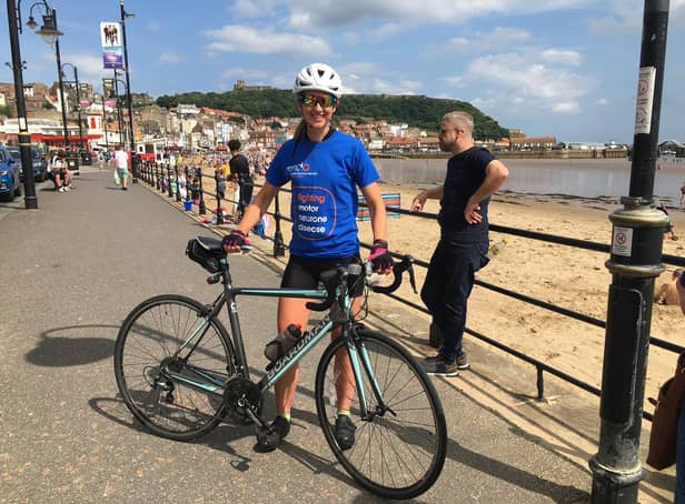 Cathy Wood on her 1,000-mile bike ride fundraiser on Foreshore Road in Scarborough. (Photo: KD Recruitment)