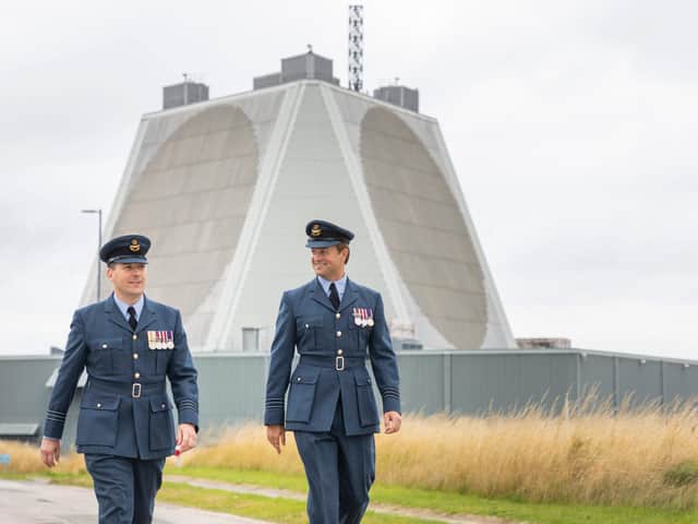 Wing Commander Al Walton with new Station Commander, Thom Colledge, walking from the radar at RAF Fylingdales.