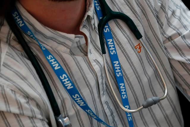 A member of NHS staff with a stethoscope. (Photo by Tolga Akmen/AFP via Getty Images)
