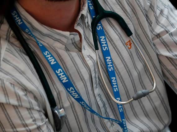 A member of NHS staff with a stethoscope. (Photo by Tolga Akmen/AFP via Getty Images)