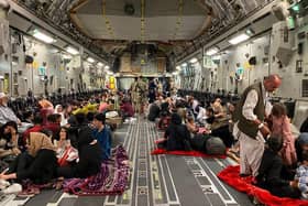 Afghan people sit inside a US military aircraft to leave Afghanistan, at the military airport in the capital Kabul. (Photo: Shakib Rahmani/Getty)