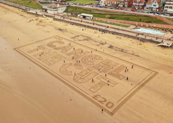 A group of about 80 individuals made up of families who rely on universal credit to put food on the table and pay their bills travelled from Chesterfield to help create a giant £20 note in the sand. Photo courtesy of Sand In Your Eye