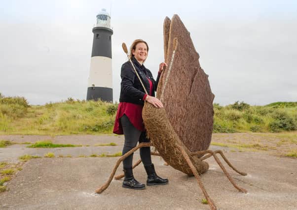 Emma Stothard with the beautiful Green Hairstreak butterfly sculpture. Photo: Richard Walker/PA Wire