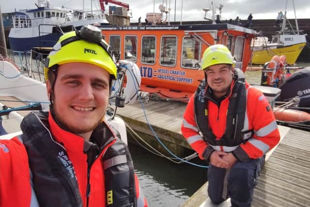Chris Warren and Neil MacInnes spotted the boy clinging to a pontoon.