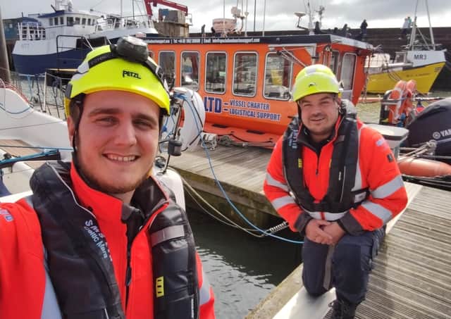 Chris Warren and Neil MacInnes spotted the boy clinging to a pontoon.
