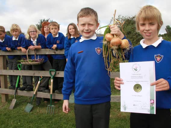 Ruswarp School’s Yorkshire in Bloom team pictured with teacher Mrs Taylor and their award.
