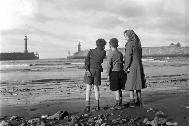Children and the piers at low tide, by John TIndale.