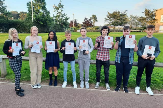 Students and their teachers celebrate the English success.