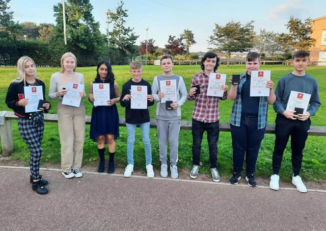 Students and their teachers celebrate the English success.