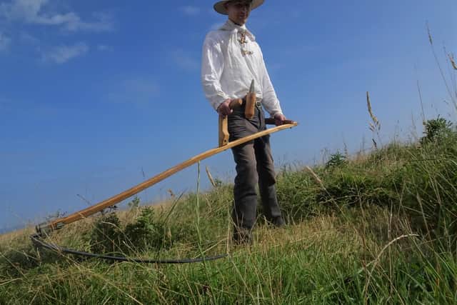Martin Stevens with his scythe at RSPB Bempton Cliffs