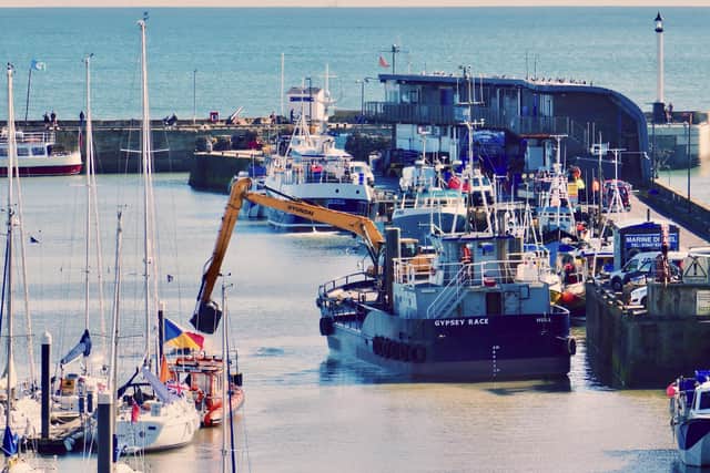 This image by Aled Jones shows the Gypsey Race dredger working in Bridlington Harbour.