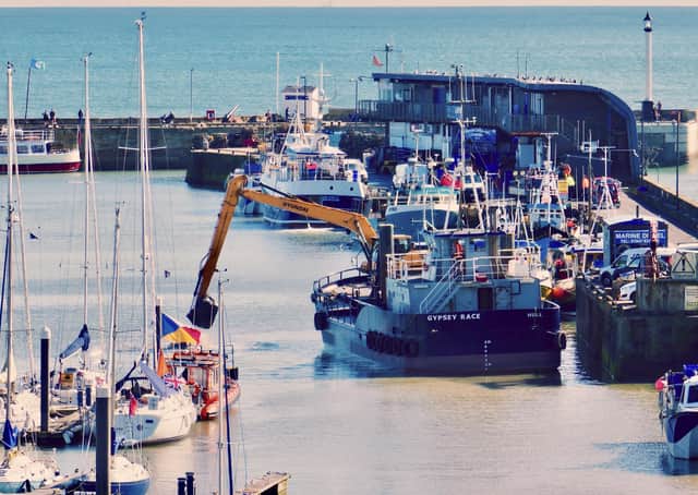 This image by Aled Jones shows the Gypsey Race dredger working in Bridlington Harbour.