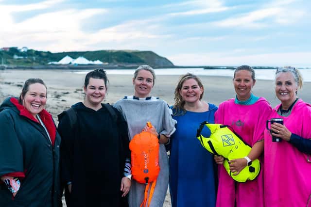 Wrapped up after the swim, from left, Roxanne Woolcott, Sam Weighell, Amy Tamblin, Diane Tricker, Louise Parkin and Helen Welford-Hall. (Erik Woolcott)