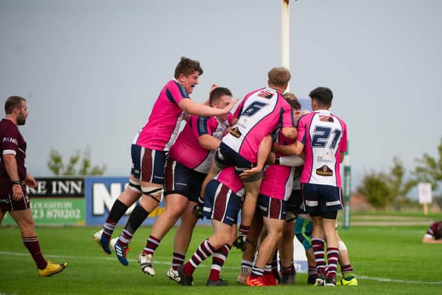 Domett is mobbed by his teammates