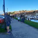 People watching the boat launch in Whitby.