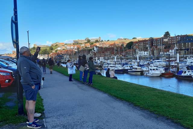 People watching the boat launch in Whitby.