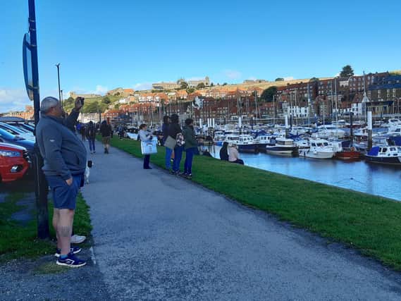 People watching the boat launch in Whitby.