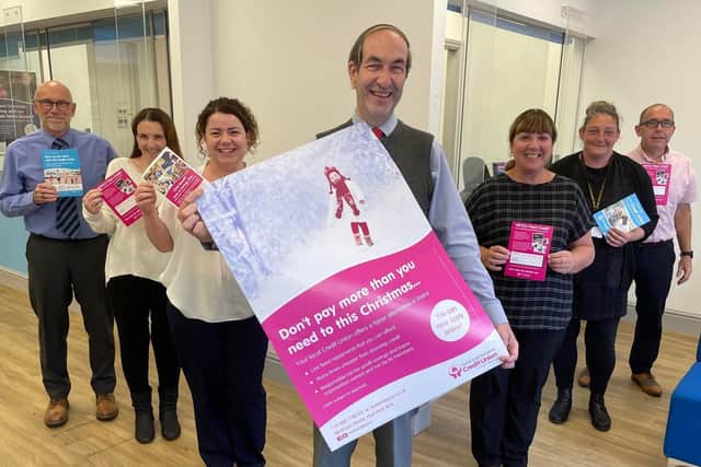 John Smith, chief executive of HEY Credit Union, and some of his colleagues celebrate their success at the Consumer Credit Awards 2021.
