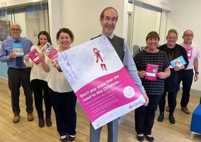John Smith, chief executive of HEY Credit Union, and some of his colleagues celebrate their success at the Consumer Credit Awards 2021.