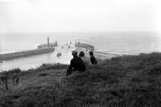 Photographer John Tindale's picture of a family watching herring boats leaving Whitby harbour.