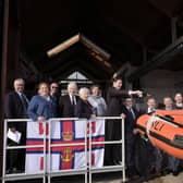 Matthew Hartley names the lifeboat as family as guests watch.