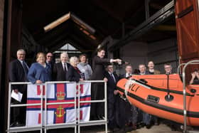 Matthew Hartley names the lifeboat as family as guests watch.