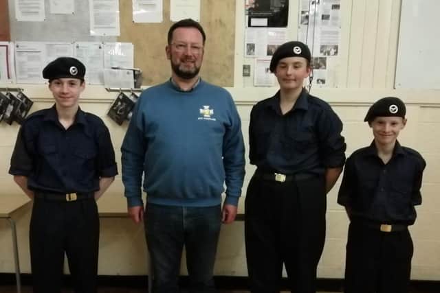 Three new recruits are pictured with Rev Matthew Pollard (Sqn Padre).