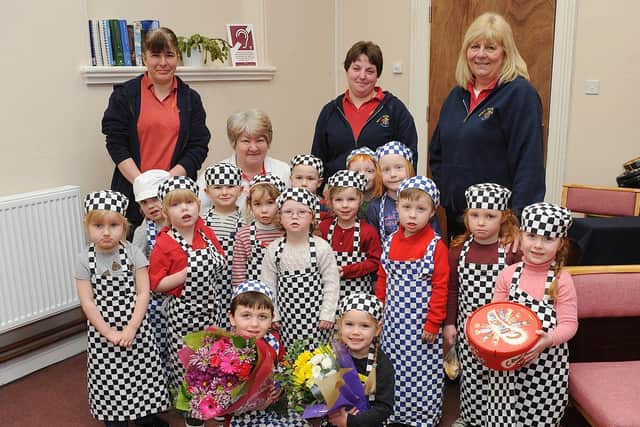 Gable House Nursery presents flowers and chocolates to the Salvation Army in 2014. Do you recognise any of the youngsters in the photograph? Picture taken by Paul Atkinson. (NBFP PA1411-4)