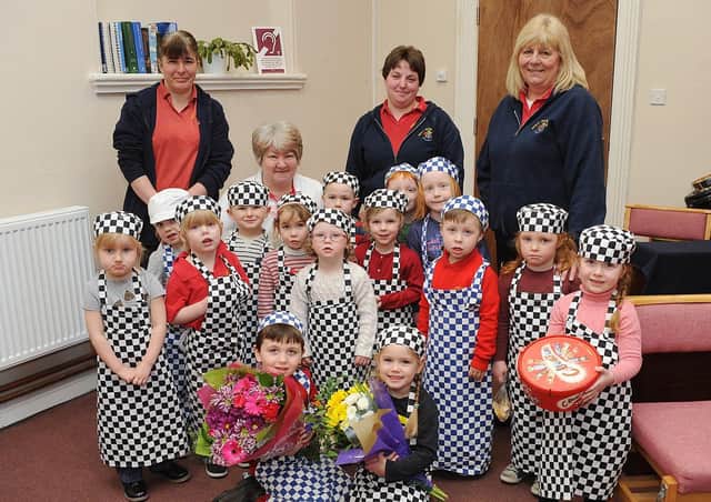 Gable House Nursery presents flowers and chocolates to the Salvation Army in 2014. Do you recognise any of the youngsters in the photograph? Picture taken by Paul Atkinson. (NBFP PA1411-4)