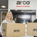 Anna Harvatt (right) from Arco hands over the first boxes containing Covid-19 PPE to Tessa Wray from the Smile Foundation. Picture: Sean Spencer/Hull News and Pictures Ltd