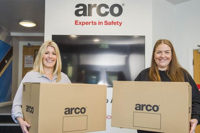 Anna Harvatt (right) from Arco hands over the first boxes containing Covid-19 PPE to Tessa Wray from the Smile Foundation. Picture: Sean Spencer/Hull News and Pictures Ltd